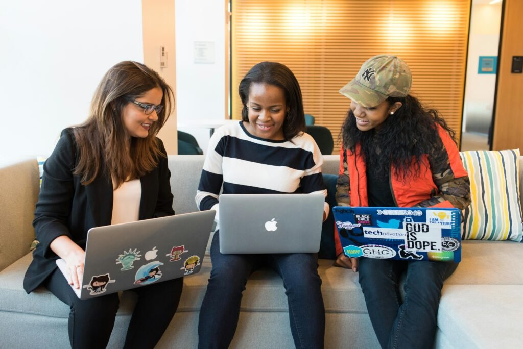 A group of young professionals discussing digital marketing strategies, powered by their online certifications | Image courtesy of Pexels